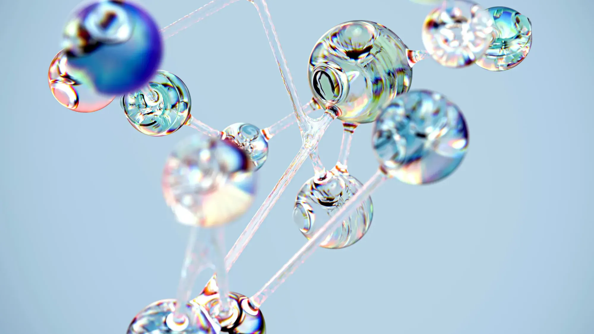 Macro photography of an interconnected network made up of glass spheres, each containing multiple smaller bubbles, suspended in the air against a light blue background, with soft lighting casting gentle shadows on their delicate forms, creating intricate patterns and reflections, symbolizing connectivity within a complex system.