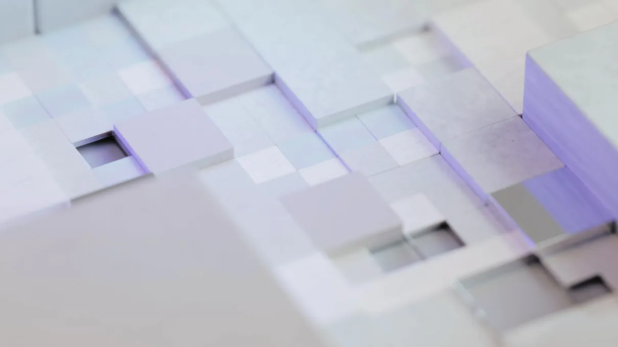 Close-up of an architectural model with white and gray squares, white background, purple accent lighting.